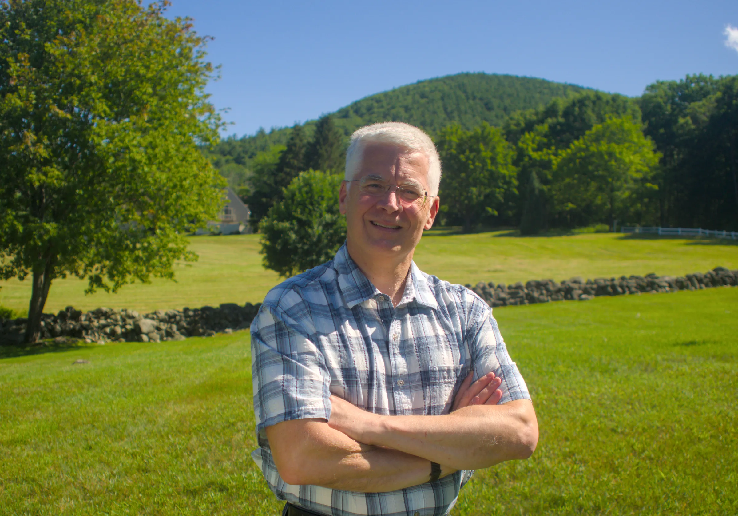 Chris Calhoun at home in Goffstown, the New Hampshire hills behind him